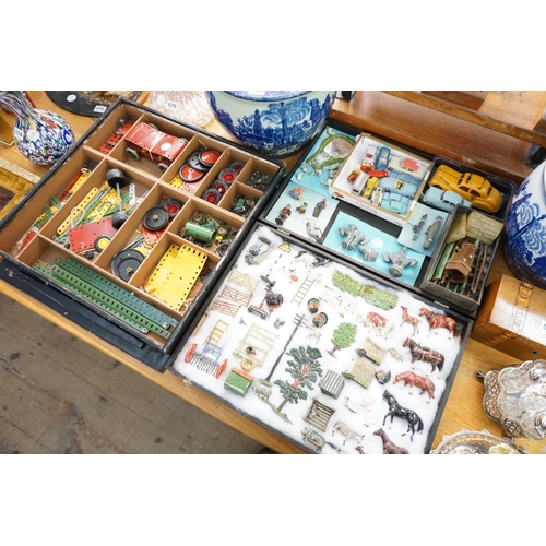 581 - An assortment of Meccano accessories, lead figures, model vehicles etc