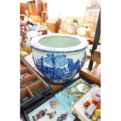 582 - A blue and white decorative planter and an assortment of cutlery