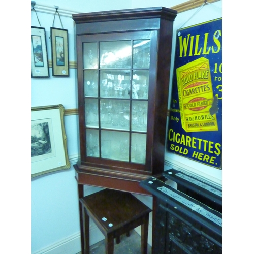 124 - A mahogany and glazed corner cabinet on stand