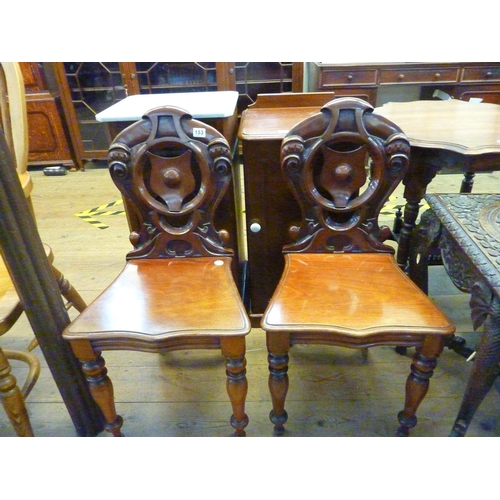 153 - A pair of Victorian mahogany hall chairs