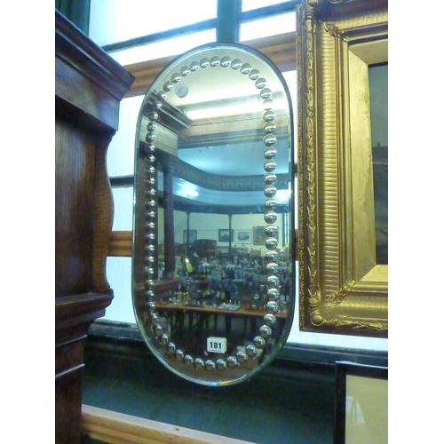 181 - A decorative oval framed mirror