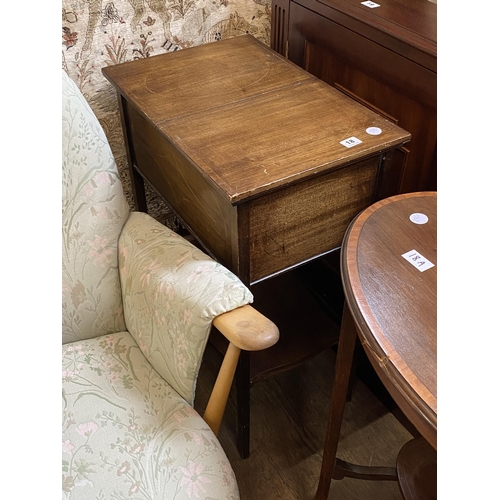 18 - An Edwardian mahogany work box with a sliding top revealing a fitted compartment