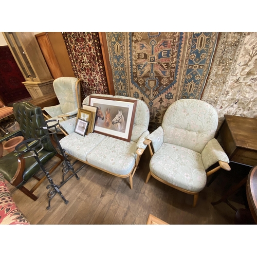 22 - An Ercol beechwood suite comprising two seater settee and 2 armchairs