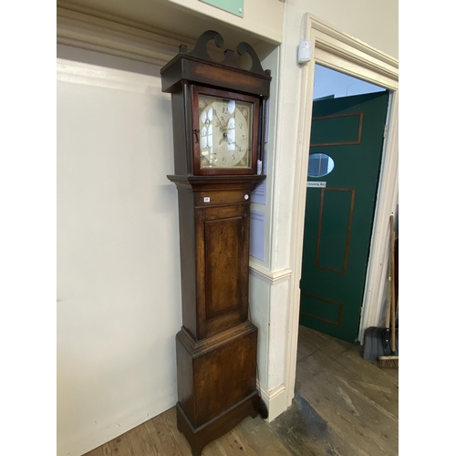 37 - An oak long case clock - 30 hour with a painted face, date dial