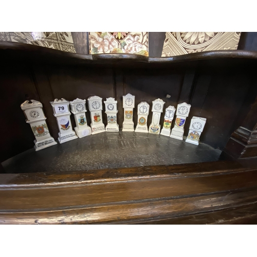 79 - A collection of miniature crested long case clocks