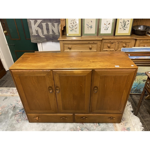 128a - An Ercol triple door sideboard with 2 lower drawers