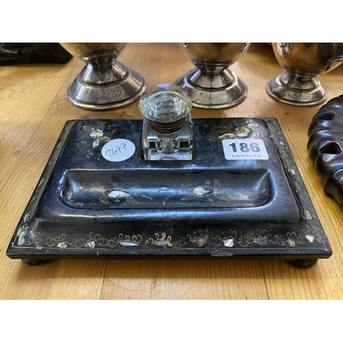 186 - A Victorian papier mache and mother of pearl inlaid inkwell desk stand