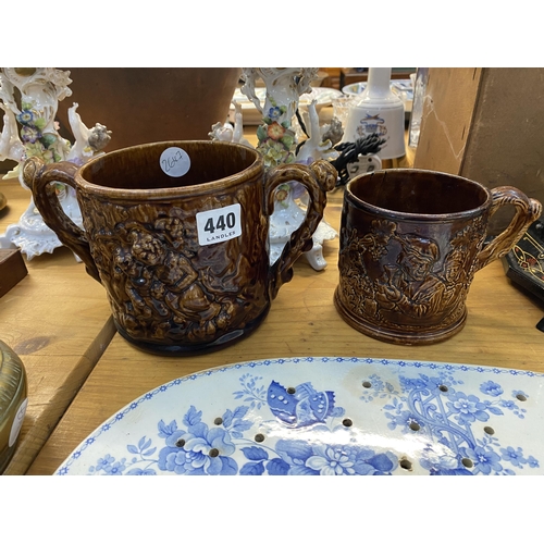 440 - A glazed pottery loving cup and another with a frog on the inside