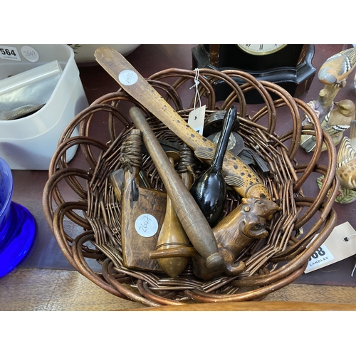 567 - A wicker basket with assorted interesting wooden items