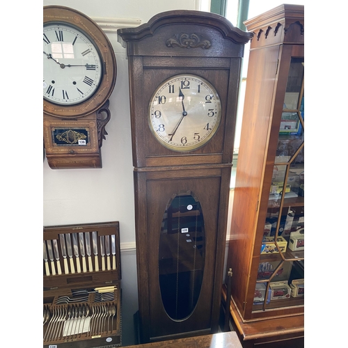 135 - An oak cased long case clock with silver dial