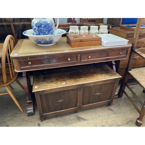 144 - A mahogany and leather top desk with 2 drawers and shaped supports to the sides (repaired)