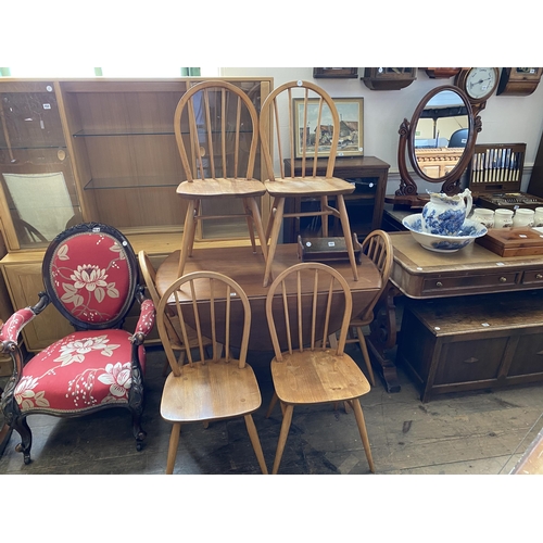 152 - An Ercol drop leaf kitchen dining table and 6 Ercol spindle backed chairs