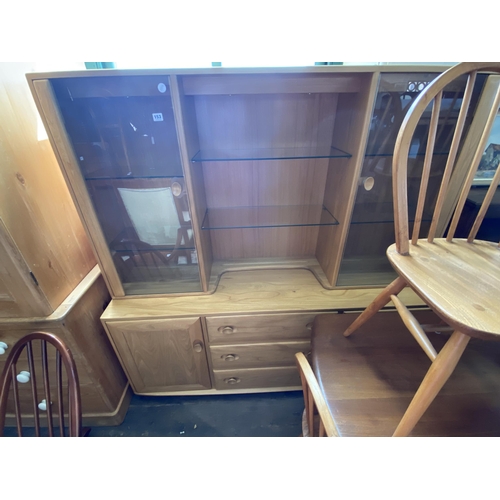 153 - An Ercol dresser with glazed doors and shelving to the top section above cupboards and drawers to th... 