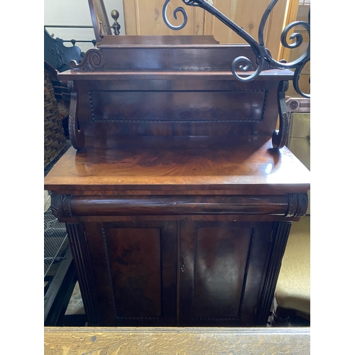 158 - A Regency chiffonier with cushion drawer above a panelled cupboard below, scrolled supports to the u... 