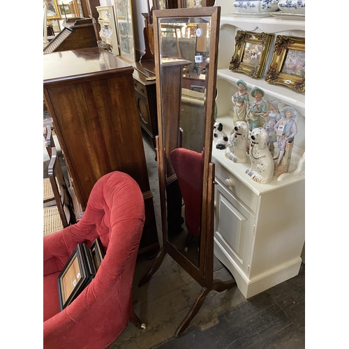 196 - An oak framed cheval mirror with bevelled glass