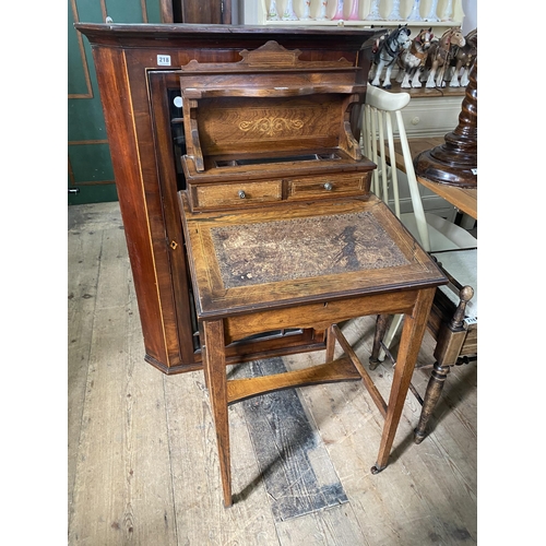 217 - A rosewood writing desk with a leather inlaid flap to the compartment, 2 drawers above with gallery,... 