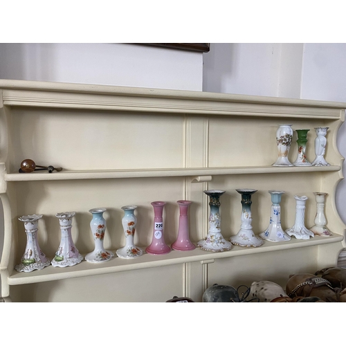 220 - A collection of assorted pottery candle sticks