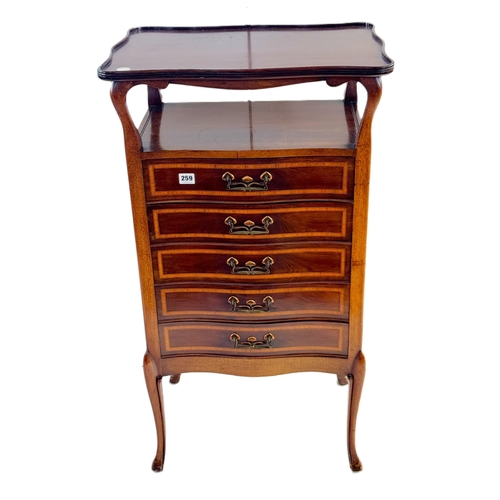 259 - A good quality Arts and Crafts serpentine fronted mahogany music cabinet with a shaped top, inlaid d... 