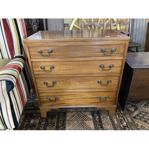 261 - A small mahogany chest of 4 graduated drawers with brass swan neck handles