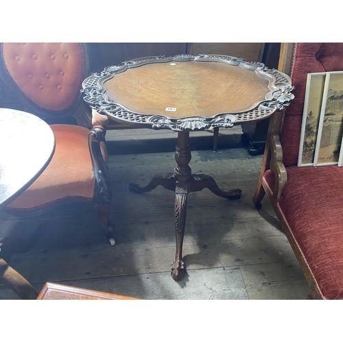 287 - A reproduction mahogany tripod table, the revolving top with fretwork detail around the edge