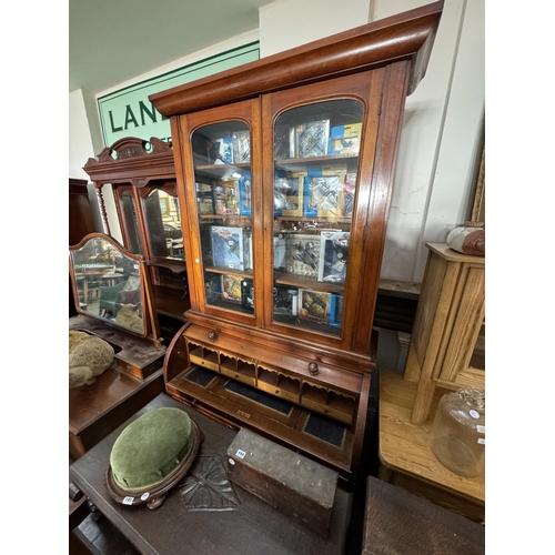 196 - A secretaire bureau bookcase with a fitted interior behind the domed front cover, birds eye maple an... 