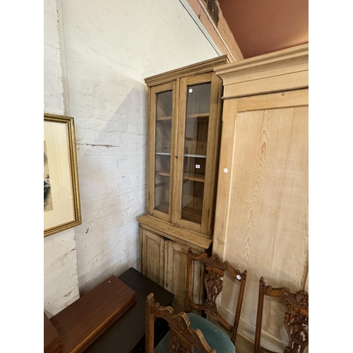 33 - A pine glazed bookcase over a double cupboard base