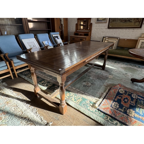 47 - A draw leaf oak refectory style dining table - 7ft long unextended and 10'2