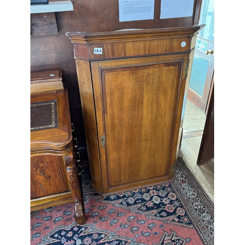 58A - An oak wall cupboard with canted corners