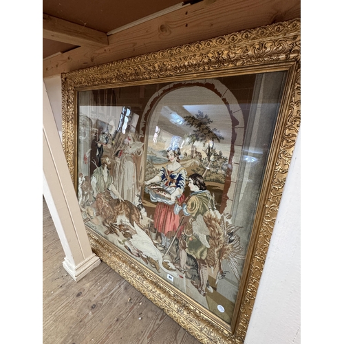 66 - A large needlework tapestry within an ornate gilded frame, depicting game, wildfowl and fish for a f... 