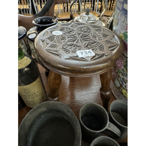 734 - A small stool with a carved detail to the top