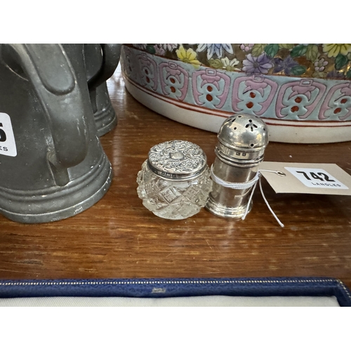 742 - A silver pepper pot and a silver topped glass pot