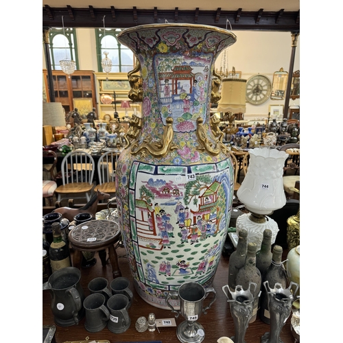 743 - A large decorative Oriental style vase depicting pergodas, family scenes, floral decoration and gild... 