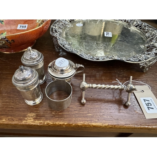 757 - Silver salt and peppers, silver lidded cruet pot, silver napkin ring and a silver knife rest