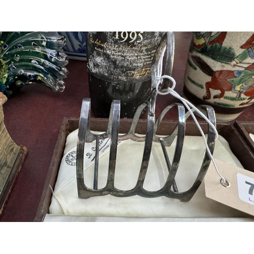 766 - A silver toast rack, a silver strainer