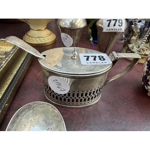 778 - A silver lidded condiment pot of ovoid form with glass liner and a silver mustard spoon