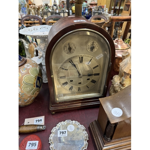 793 - A mahogany bracket clock with an arched case, arched bevelled glass door to the front, silvered dial... 