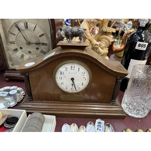 802 - A mahogany cased mantel clock by Harrods Ltd with a French movement, decorative pillars each side of... 