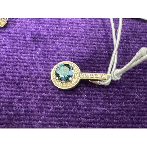 832 - An 18ct white gold pendant set with a blue diamond