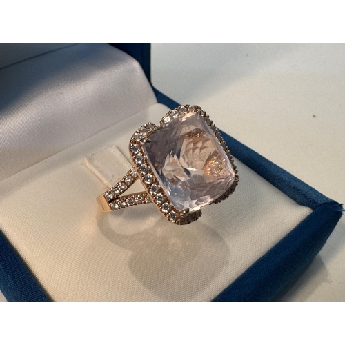 832a - A rose gold ring set with a 14.95ct kunzite surrounded by diamonds