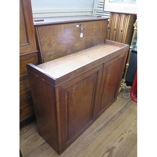 67 - An early 19th century mahogany secretaire cabinet, the pair of panelled doors enclosing adjustable s... 