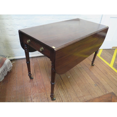 69 - A Regency mahogany Pembroke table, with frieze drawer on ring turned tapering legs and brass castors... 