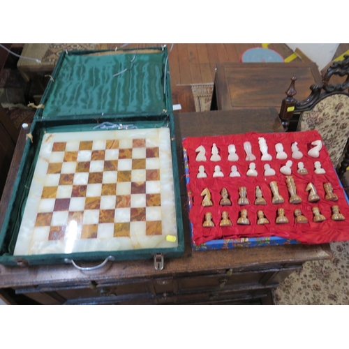 189 - An onyx chess set, in green and brown, in a felt case, board 40.5 cm square, some damage to the piec... 