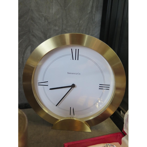 100 - A Tiffany & Co table clock, with heavy brass frame, quartz movement, 16 cm high