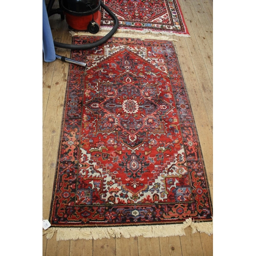 111 - An Heriz style Louis De Poortere rug, 167 x 91 cm, and another similar rug, 150 x 100 cm (2)