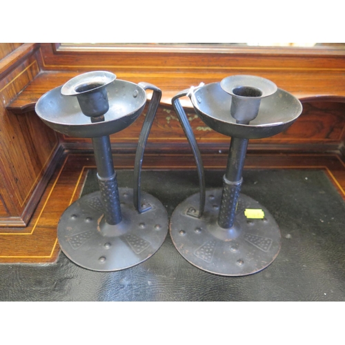 182 - A pair of Goberg style bronzed metal candlesticks, in the Arts and Crafts style, 20 cm high