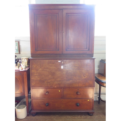 67 - An early 19th century mahogany secretaire cabinet, the pair of panelled doors enclosing adjustable s... 