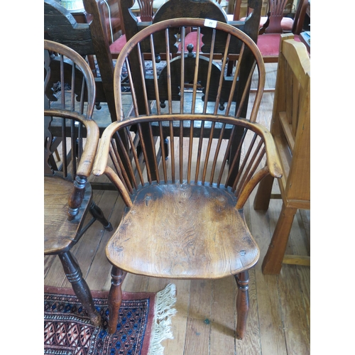 77 - A yew and elm spindle back Windsor chair, with moulded seat and turned legs joined by turned stretch... 