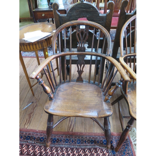 78 - A yew and elm Windsor chair, the spindle back with pierced splat over a moulded seat on ring turned ... 