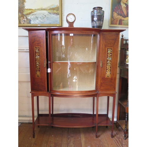 83 - An Edwardian mahogany and satinwood crossbanded display cabinet, the protruding cornice over a bowed... 