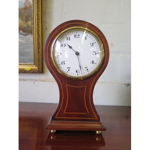 86 - An Edwardian balloon shape table clock timepiece, the enamel dial within a mahogany and boxwood stru... 